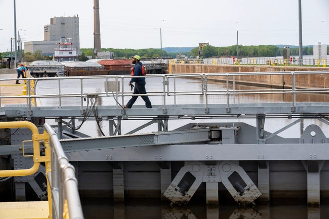 A crew member from the tug Theresa L. Wood walks across a miter gate as it enters Lock and Dam #8 Wednesday, May 17, 2023 in Genoa, Wis. The vessel was moving barges from St. Louis to Winona, Minn. The gate was installed in 2022. The locks allow the boats to gradually adjust to changing river levels. Most towboats can push 15 barges at a time on the river. When those barges reach a 600-foot long lock, they don’t fit. Instead, they have to be split up, which takes more than twice as long.It was constructed and was put into operation by April 1937.