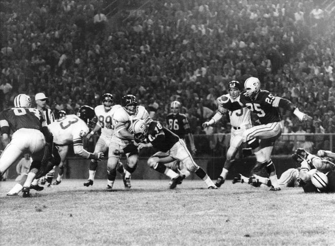 Packers halfback Tom Moore runs for 16 yards against the New York Giants during the fourth quarter of their exhibition game at Green Bay in Sept. 1961.