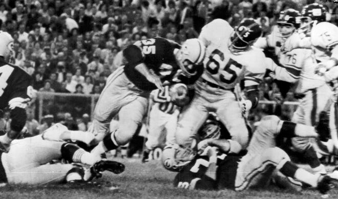 A 1964 Press Photo shows Green Bay Packers fullback Frank Mestnik, a former Marquette university star, rushing for seven yards against the New York Giants during the first quarter of their exhibition game at Green Bay in 1963.
