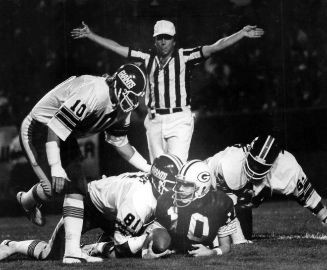 The Giants swarmed all over Packer quarterback Lynn Dickey during the first quarter play during an exhibition game in 1976.