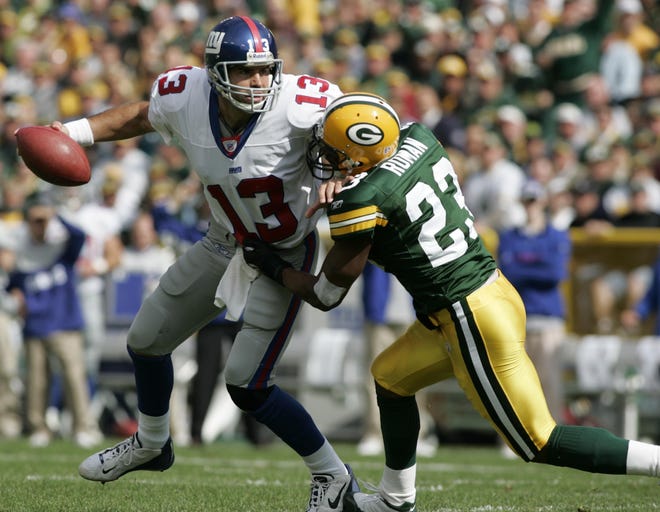 Green Bay Packers safety Mark Roman sacks New York Giants quarterback Kurt Warner during the first quarter of their game on October 3, 2004 at Lambeau Field in Green Bay, Wis.