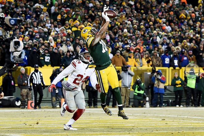 Randall Cobb (18) of the Green Bay Packers catches a touchdown pass against Eli Apple (24) of the New York Giants during the fourth quarter of their NFC Wild Card game at Lambeau Field on January 8, 2017, in Green Bay, Wis. The Packers won 38-13.