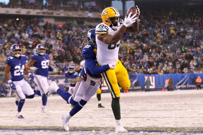 Green Bay Packers' Marcedes Lewis catches a touchdown during the second half of an NFL football game against the New York Giants on Dec. 1, 2019, in East Rutherford, N.J.