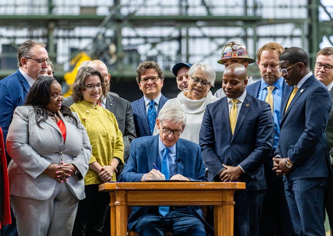 Gov. Tony Evers signs Assembly Bill 438 and Assembly Bill 439, a bipartisan package of bills passed by the Wisconsin State Legislature to keep the Milwaukee Brewers and Major League Baseball (MLB) in Wisconsin through 2050, on Tuesday December 5, 2023 at American Family Field in Milwaukee, Wis.