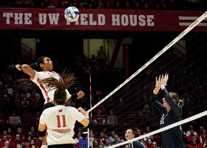 Wisconsin setter Izzy Ashburn (11) sets the ball for a spike from middle blocker Carter Booth (52) during the first set of the NCAA Regional Volleyball semifinal match against Penn State on Thursday December 7, 2023 at the UW Field House in Madison, Wis.