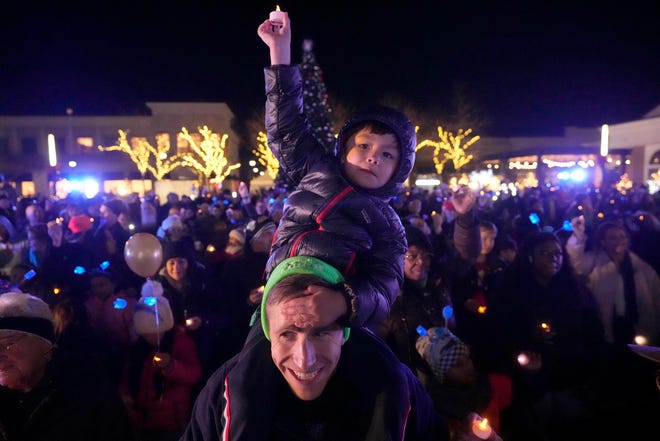 State Rep. Daniel Riemer, of Milwaukee, holds his five-year-old son, Nathaniel, on his shoulders during the Chanukah Festival and Gelt Drop, to kick off the first day of Chanukah, in The Yard at Bayshore in Glendale on Thursday, Dec. 7, 2023. The largest Hanukkah festival in Wisconsin, hosted by Lubavitch of Wisconsin, included live music, a giant Menorah lighting, and a mega gelt and gift drop.