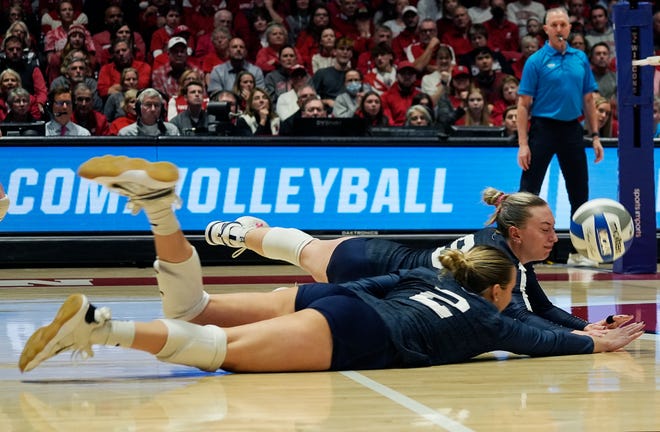 Penn State outside hitter Jess Mruzik (9) and defensive specialist Maddy Bilinovic (2) dive for the ball during the second set of the NCAA Regional Volleyball semifinal match against Wisconsin on Thursday December 7, 2023 at the UW Field House in Madison, Wis.