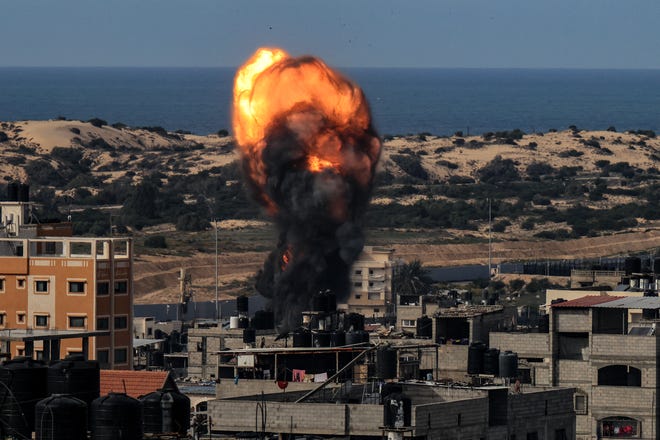December 9, 2023:A ball of fire rises above a building during an Israeli strike, in Rafah in the southern Gaza Strip amid continuing battles between Israel and the militant group Hamas. Israel pressed its offensive against Hamas militants in Gaza on Dec. 9 after the United States blocked an extraordinary UN bid to call for a ceasefire in the two-month war