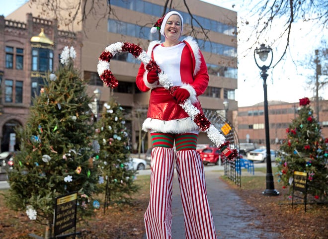 Jess Clark, a stilt walker with the Jolly Giants, poses for a photo during the Cocoa with the Clauses event in Cathedral Square Park in Milwaukee, Wis. on Saturday, Dec. 9, 2023.