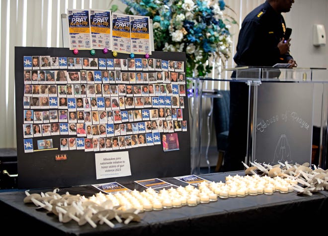 A display at the front of the church shows photos of individuals who lost their lives to violence at a candlelit vigil honoring and remembering victims of violence in Milwaukee at House of Prayer in Milwaukee, Wis. on Saturday, Dec. 9, 2023.