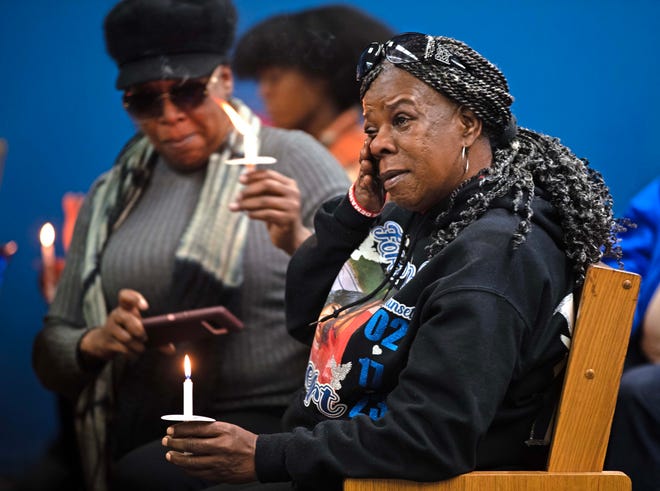 Julie Powell wipes her eyes during a candlelit vigil honoring and remembering victims of violence in Milwaukee at House of Prayer in Milwaukee, Wis. on Saturday, Dec. 9, 2023. Powell lost her son to gun violence.