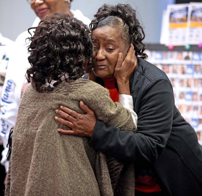 Linda Carter hugs a friends during a candlelit vigil honoring and remembering victims of violence in Milwaukee at House of Prayer in Milwaukee, Wis. on Saturday, Dec. 9, 2023. Linda lost her son James Carter to gun violence about a year ago.